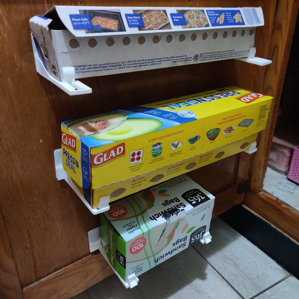 Adjustable wrap holder for kitchen cabinets